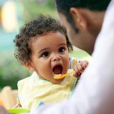 small child eating food aww, look at the widdle babbyyy!!